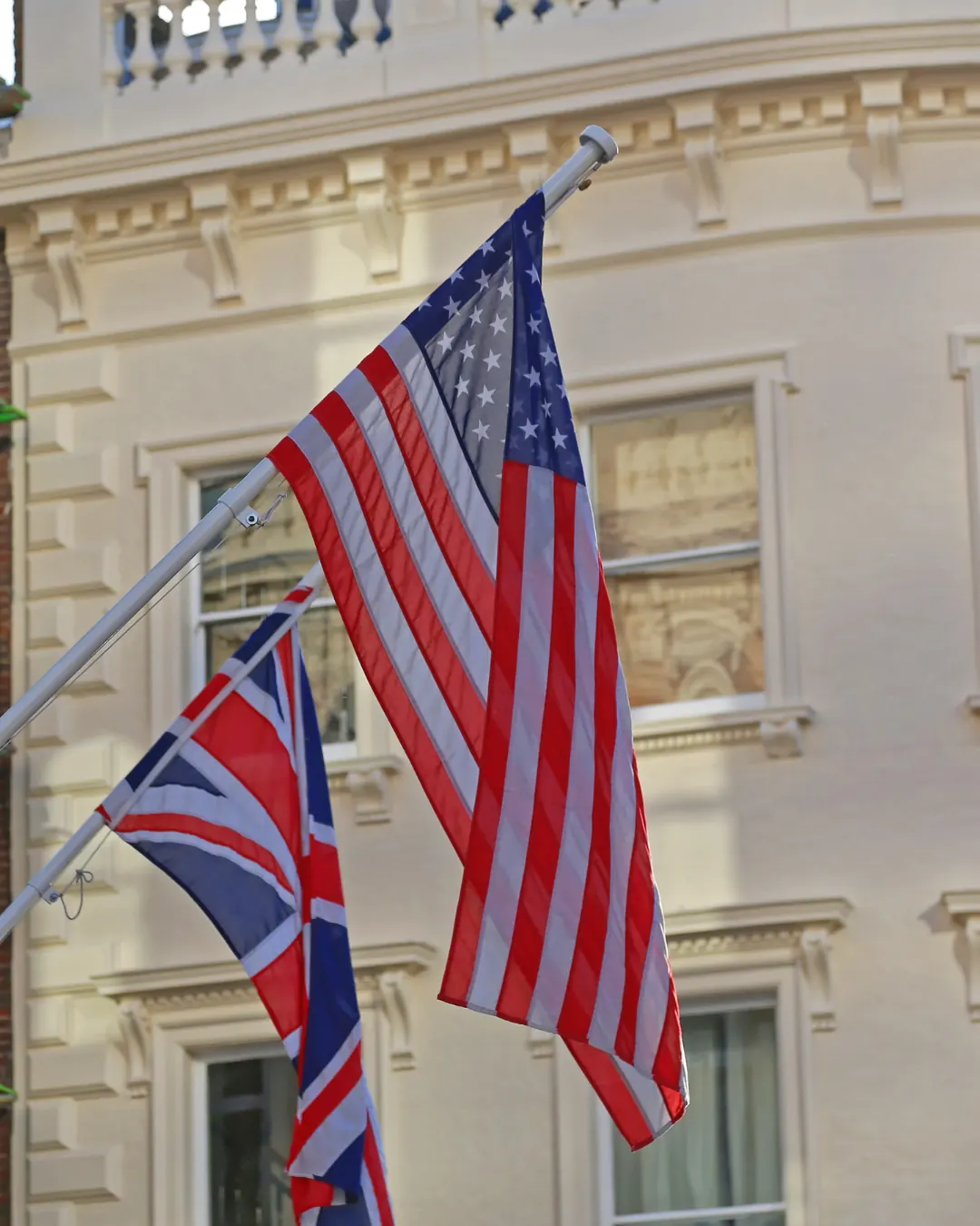 The US and UK flags side by side on a building