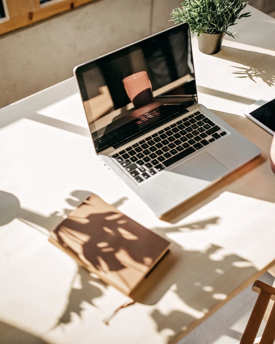 A laptop on a sunlit desk
